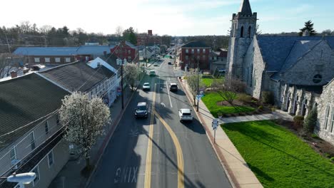 Aerial-view-of-cars-driving-through-the-street-of-a-small-town-in-America,-Mount-Joy,-USA