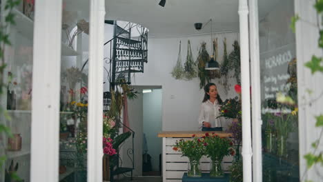 rested florist start work day in flower store. businesswoman open floral shop.