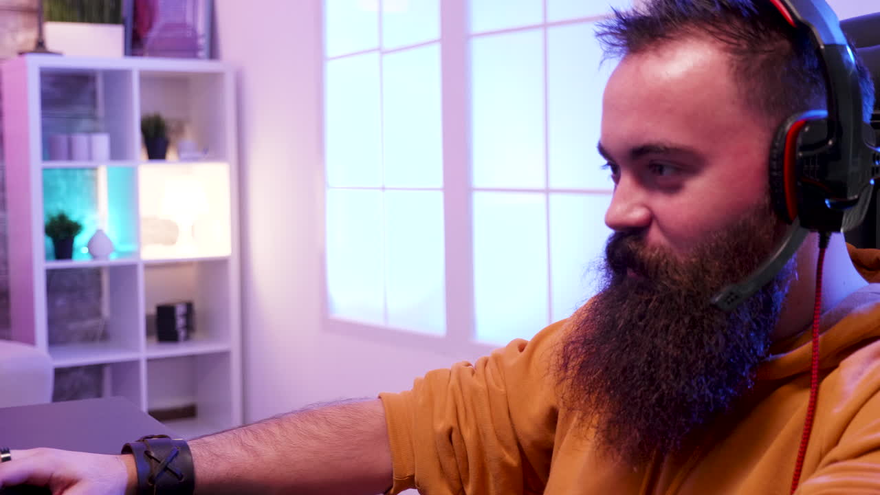 Gamer with headphones playing computer games