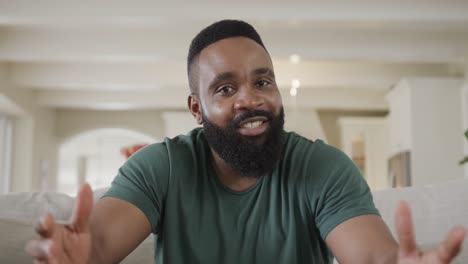 happy african american man making video call at home, slow motion
