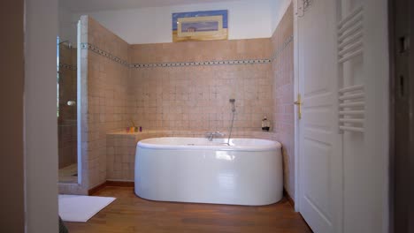 slow dolly towards a free-standing bath with antique tiles within a french chateau