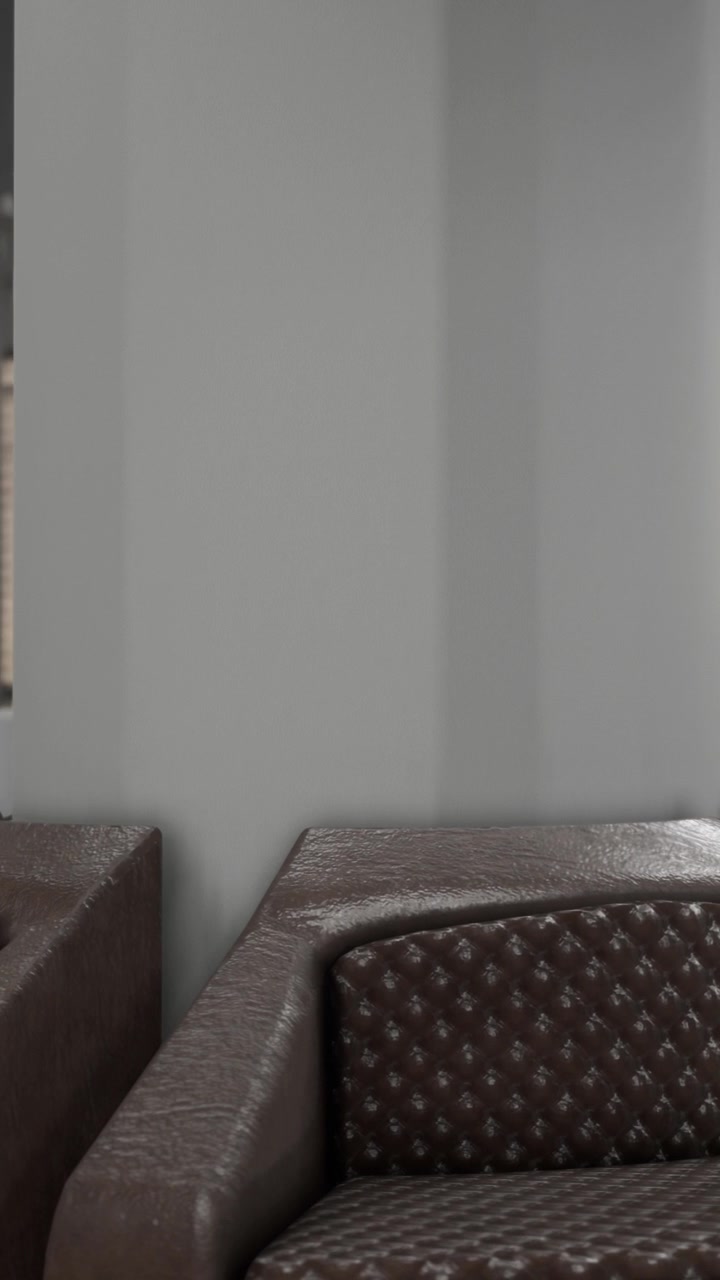 Divani in una sala d'attesa vicino a una parete grigia all'interno di un edificio moderno.