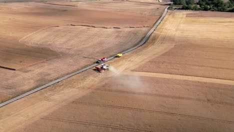 combine harvesters harvesting rural fields with ripe crops in sweden