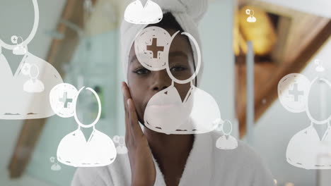 animation of people icons over african american woman applying cream