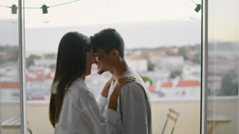 cute newlyweds dancing home closeup. couple celebrating at sea panorama hotel