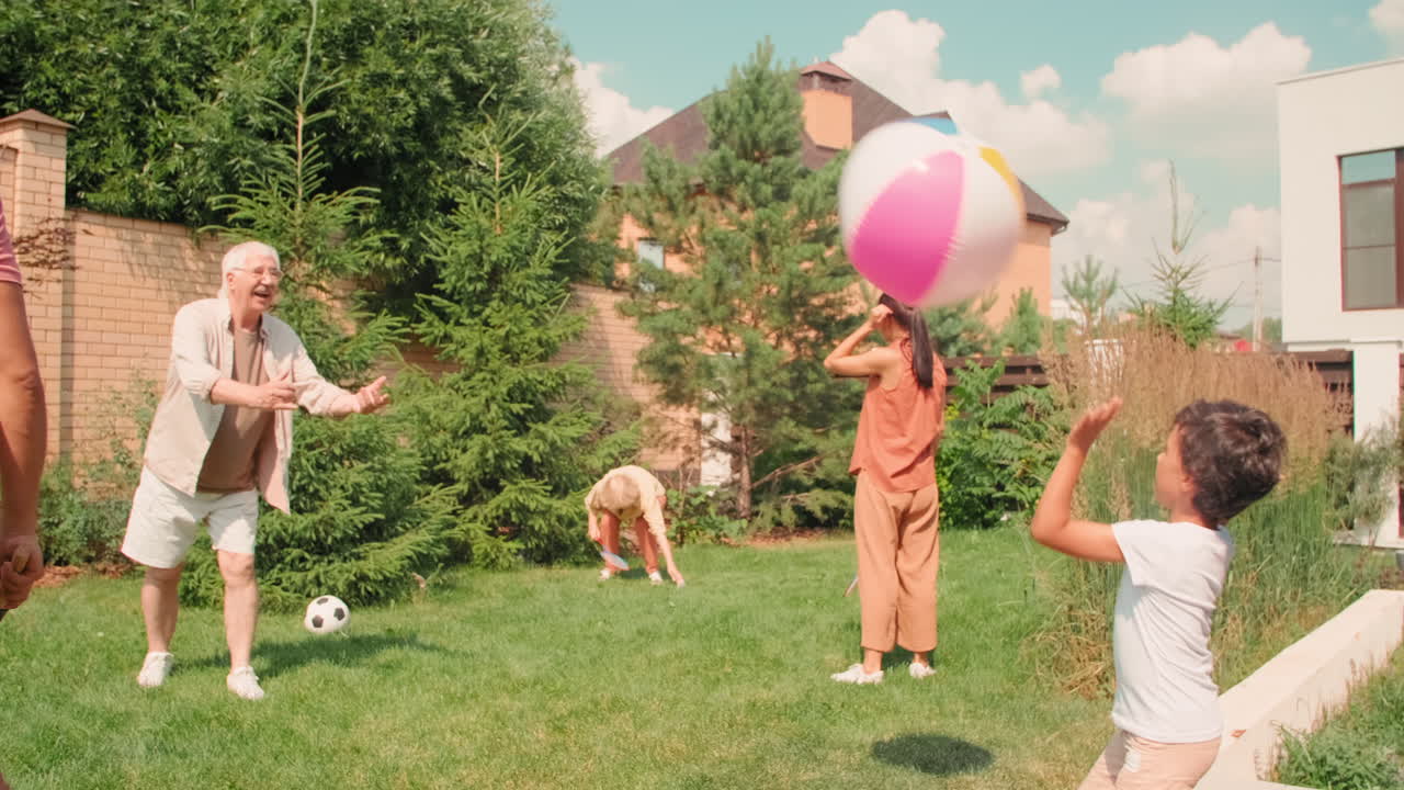 Big Family Playing On Lawn In Backyard