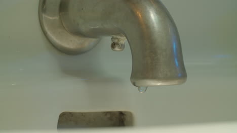 Slow-motion-medium-shot-of-faucet-as-a-single-drop-of-water-falls