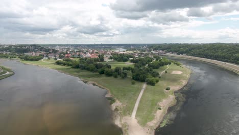 beautiful shot of neris and nemunas river confluence with kaunas old town city in background, aerial drone shot.