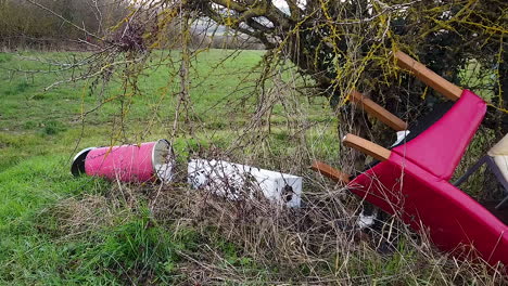 illegal fly tipping of office furniture and equipment at the side of an english rural road