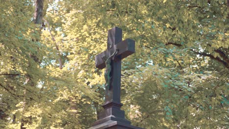 christian cross as a tombstone in graveyard munich