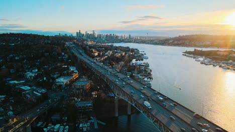 aerial rising shot overhead lake union bridge at sunset overlooking seattle