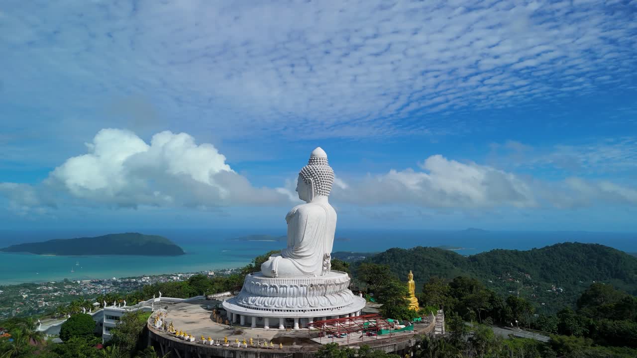 Aerial slow orbit left circles Phuket Big Buddha on Khao Nakkerd with Andaman views