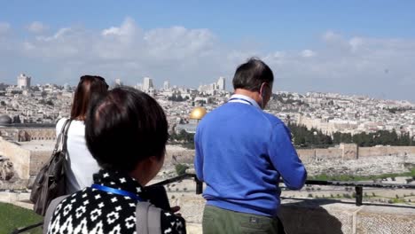 tourists photographing the dome of the rock in jerusalem