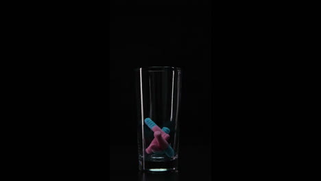 Candy-falling-down-in-empty-glass.-Slowmotion