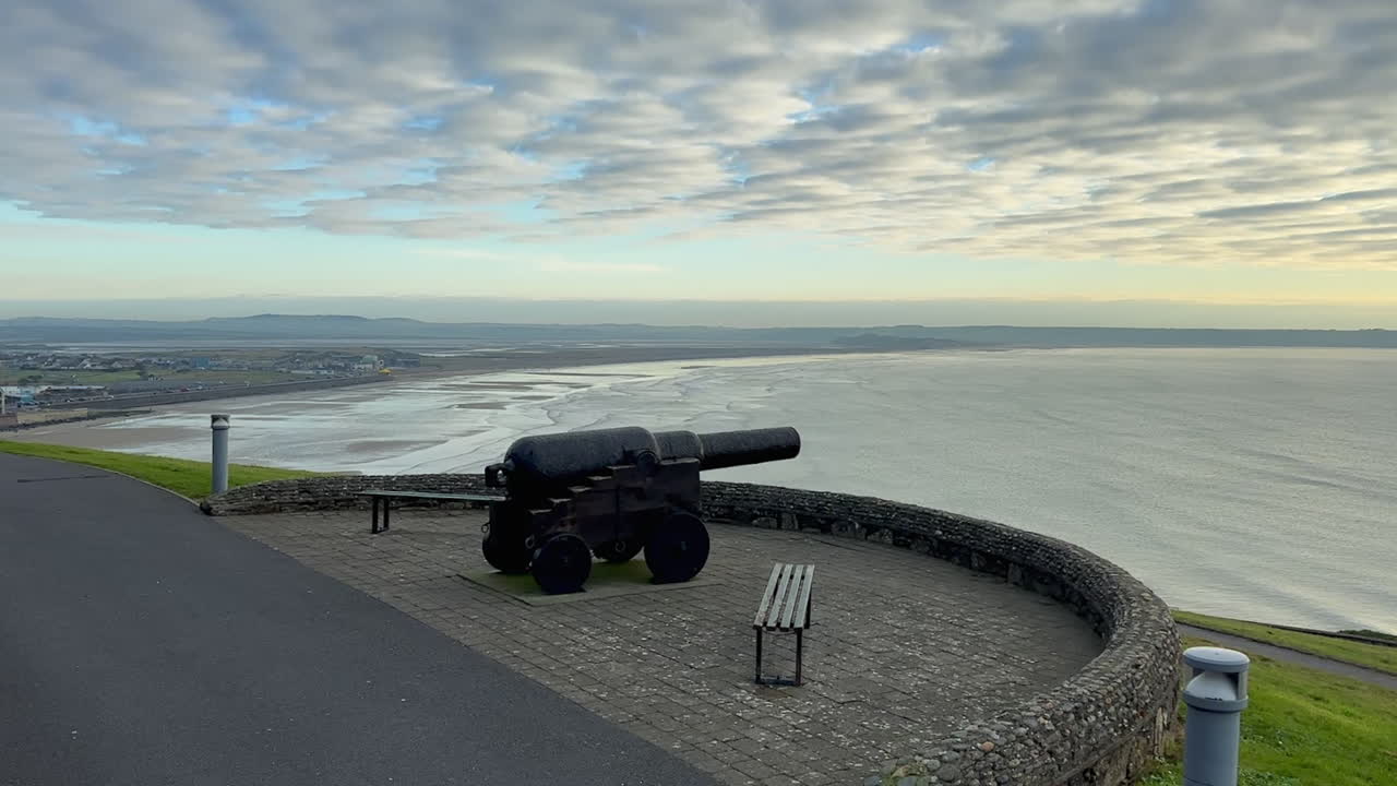 Old iron cannon guards Tramore Bay on County Waterford, Ireland coast
