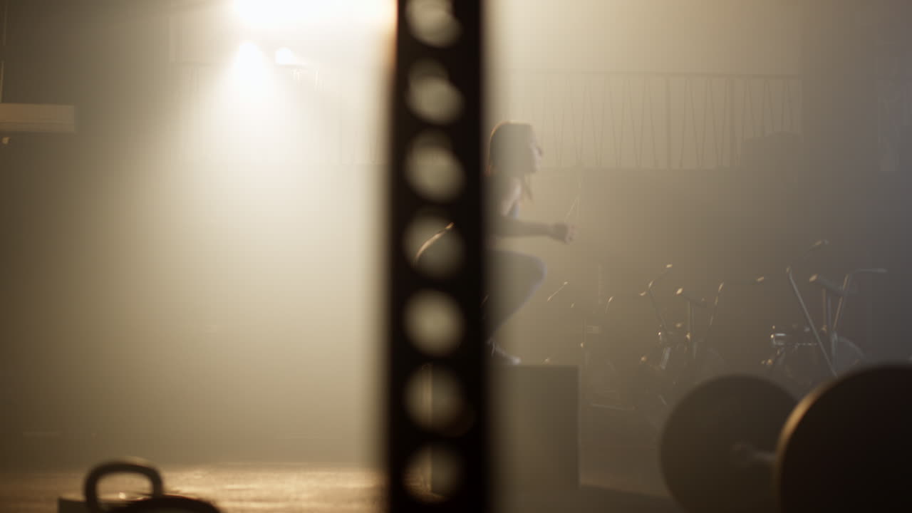 Woman doing box jumps in a smoky gym