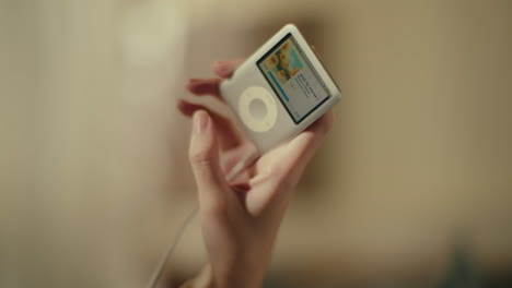 person holding a vintage ipod