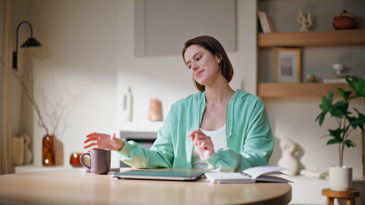 Satisfied businesswoman closing laptop at home remote workplace. Smiling woman