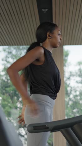 woman stretching and warming up on a treadmill