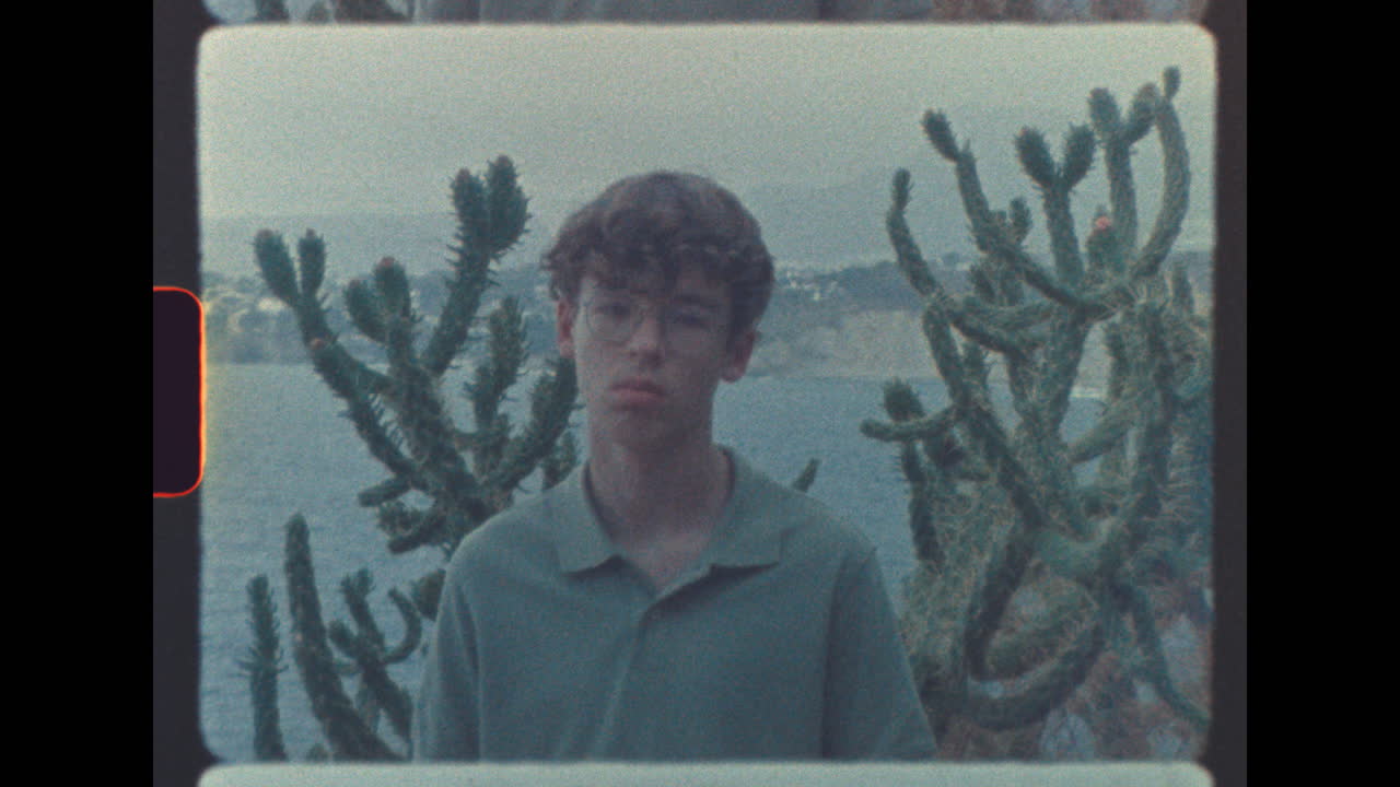 Teenager in front of cactus and ocean