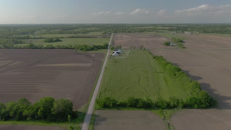 aerial view moves down country road in kansas