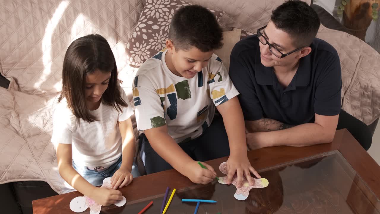 High angle view of a family doing crafts and painting at home