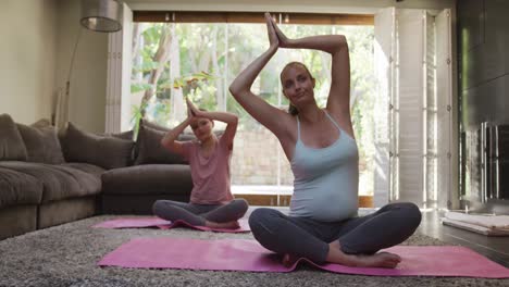 mother and daughter doing yoga