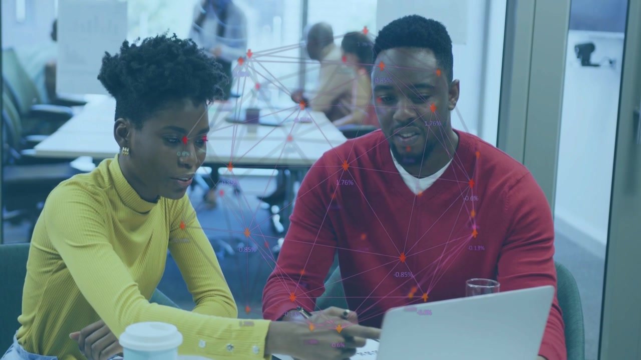 Man gesturing at laptop, woman leaning and touching screen, checking tech data with network overlay