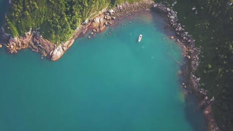 aerial pan over paradisiac island in brazil with boat