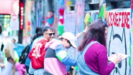 artists painting a mural in melbourne's iconic alley