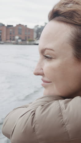 woman enjoying a view of the city by the river