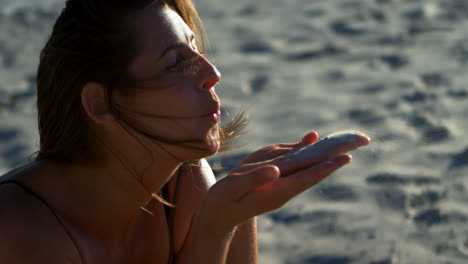 Female-volleyball-player-blowing-sand-in-the-beach-4k