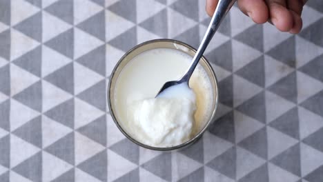 Glass-of-whole-cream-milk-on-table-,