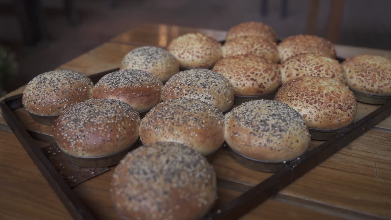 Close up shot of delicious homemade burger bread with seeds on wooden table