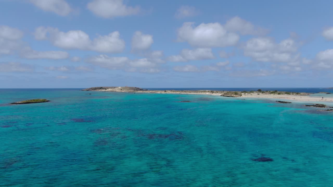Elafonissi Beach Azure color waters in Kissamos province of Crete Greece, Aerial pan left shot
