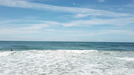 Aerial-view-of-a-blue-sea-with-beautiful-waves-at-sunny-day-in-summer