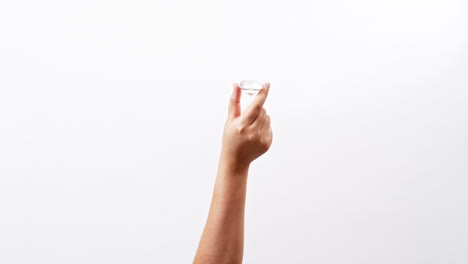 large polished round cut diamond in hand close up isolated on a white studio background with copy space for placing a text for an advertisement.