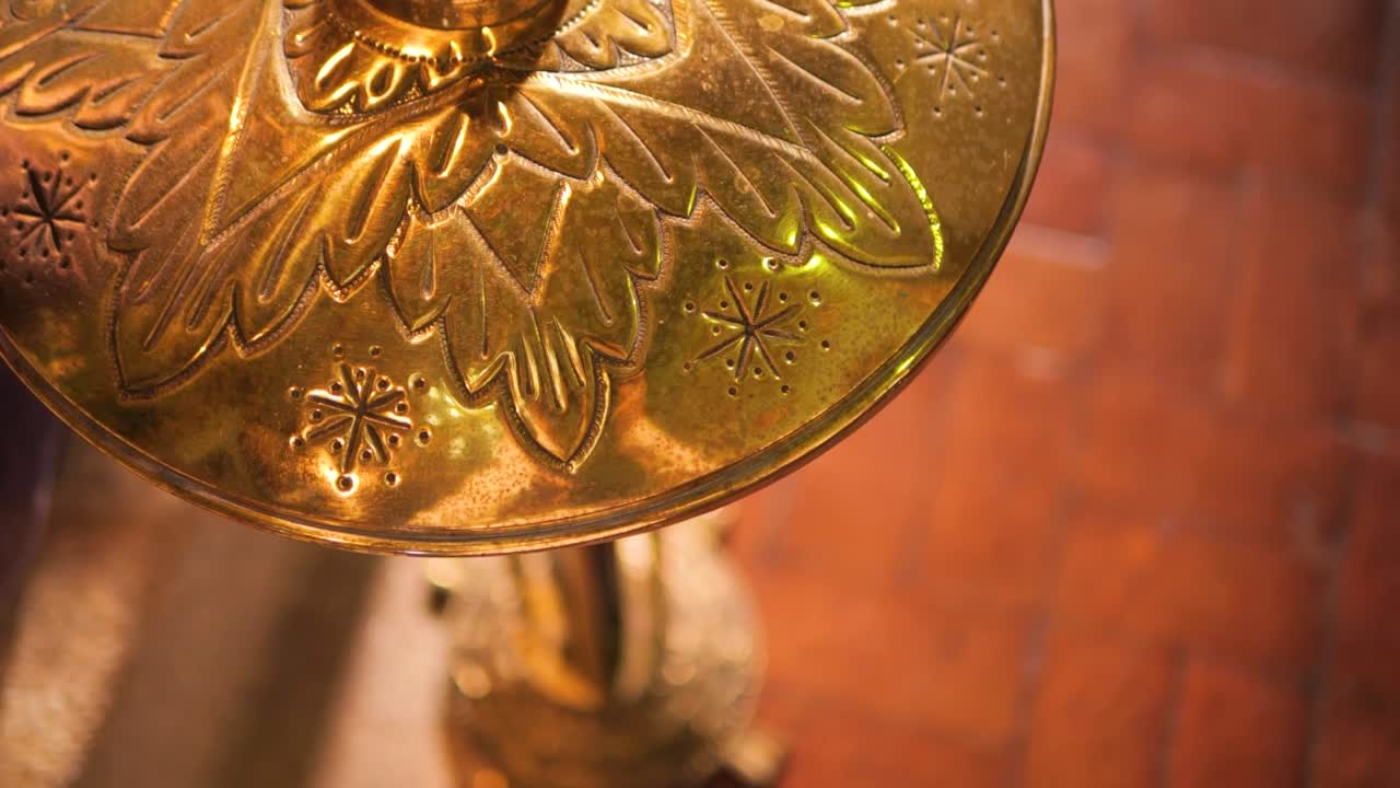 Ornate Christian Cross on Baptismal Font – Sacred Church Detail