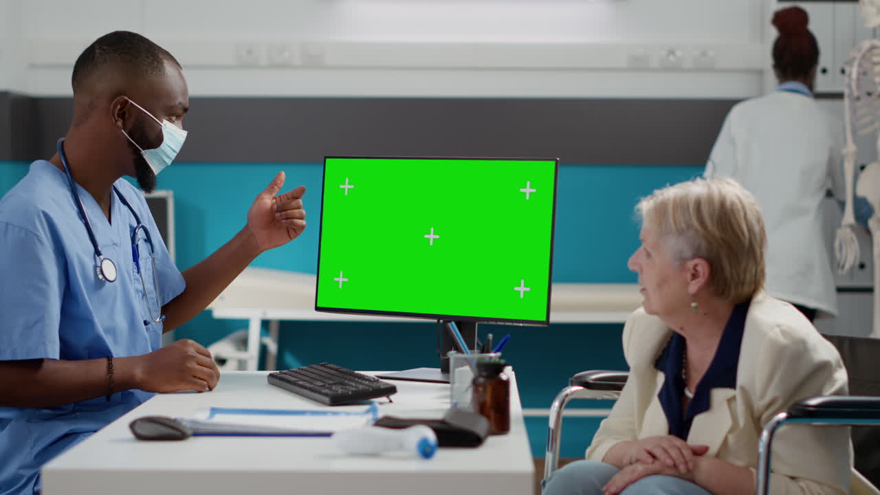Medical consultation with doctor and patient using green screen monitor