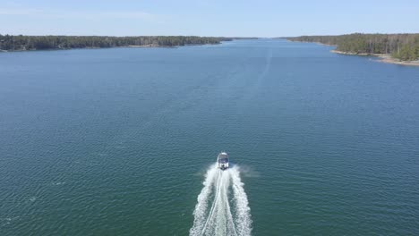 small speed boat travelling at fast speed in finnish archipelago