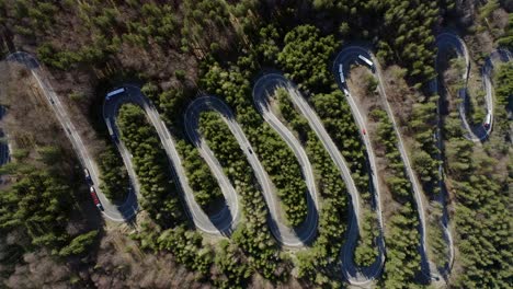 bird's eye view of curvy winding road with trucks and cars passing