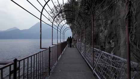 walking near the lake como on a cloudy day, varenna, italy