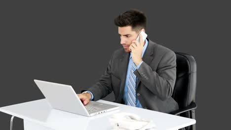 Young-businessman-working-at-his-desk