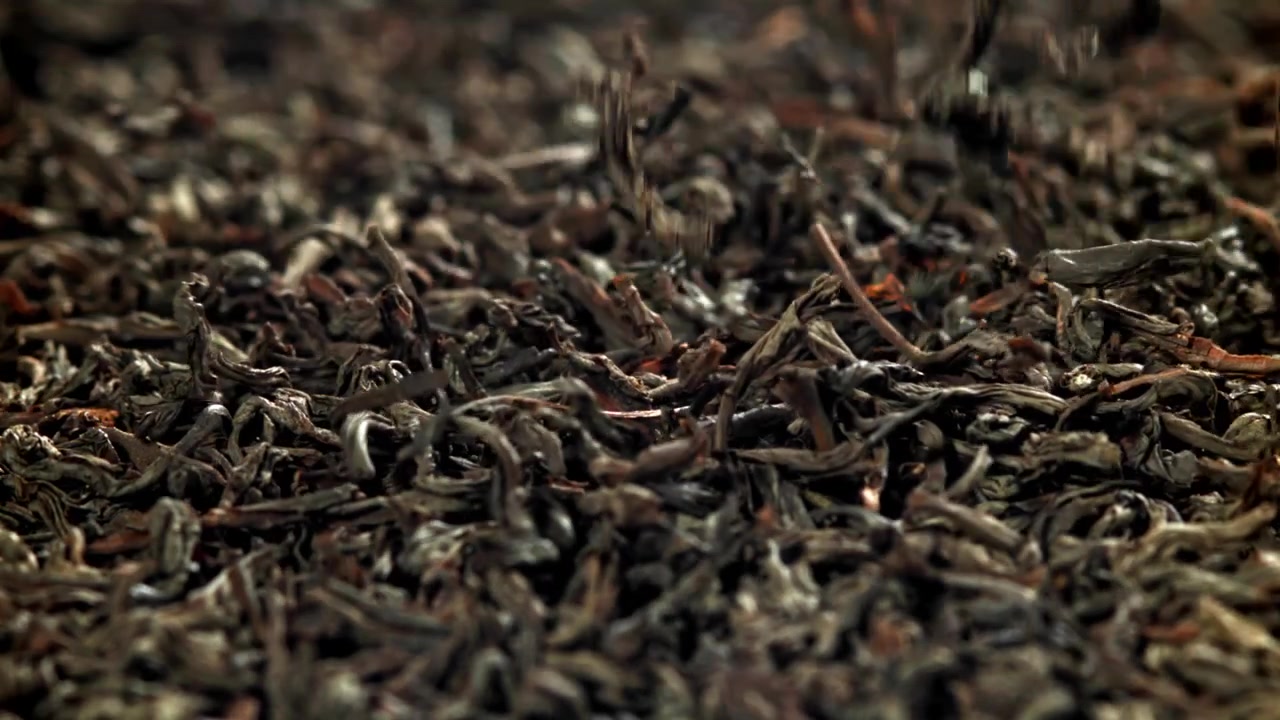 Dried Black Tea Leaves Falling in Slow Motion