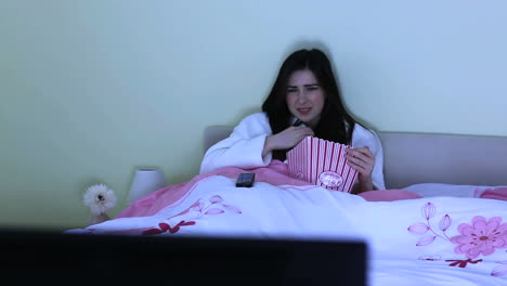 young woman watching horror movie