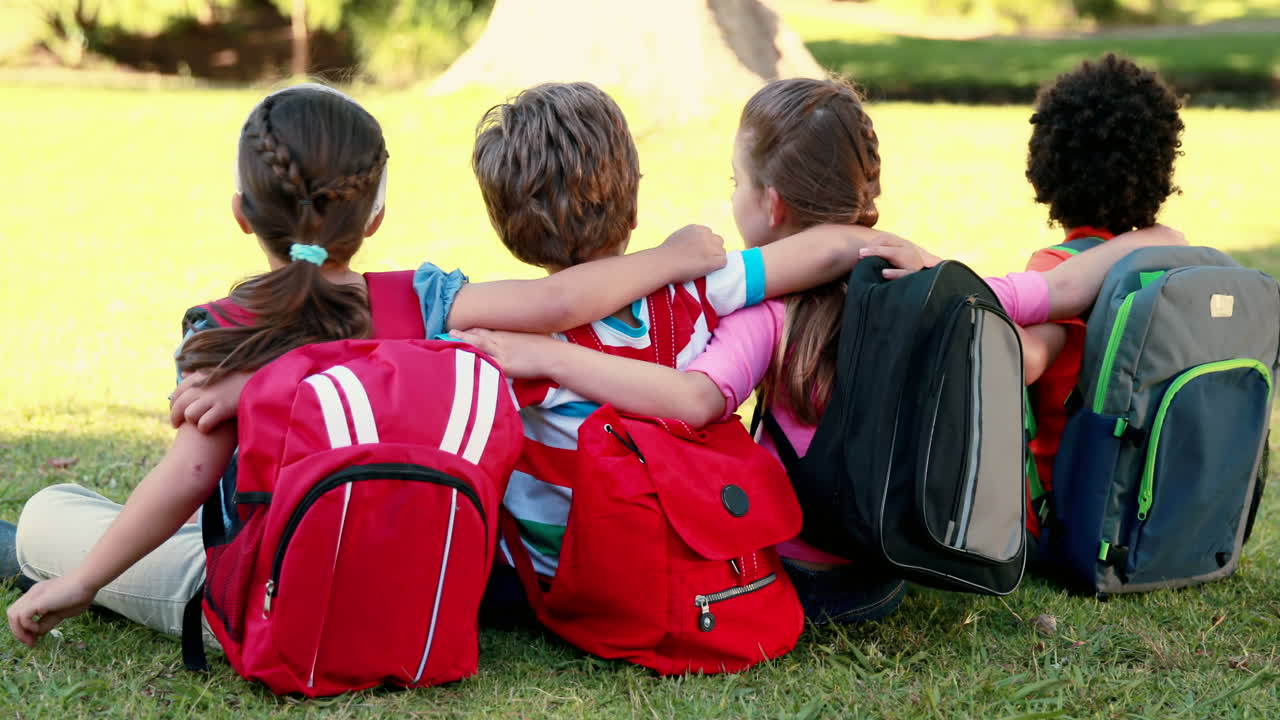 School children sitting on grass
