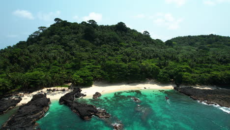 Drone-Volando-Lejos-De-Un-Barco-Que-Llega-A-La-Playa-Del-Café-En-La-Isla-De-Rolas,-Santo-Tomé