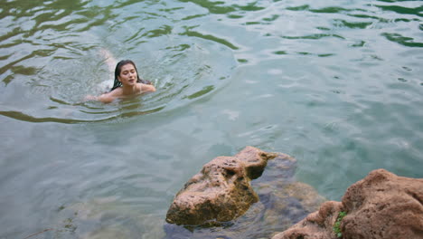 woman swimming in a crystal clear lake