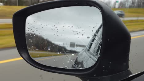 rainy day drive: view from the side mirror