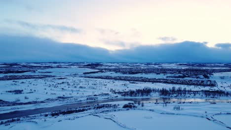 A-drone's-eye-view-captures-the-serene-beauty-of-a-snow-covered-neighborhood-as-the-sun-sets